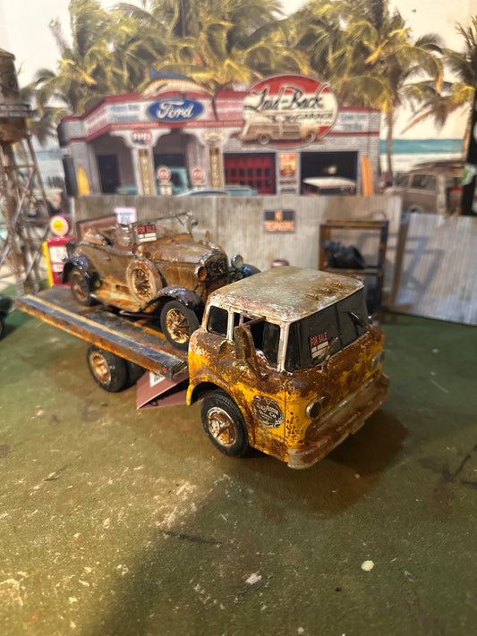 1931 Ford Model A on a 1958 Ford C800 COE truck  . A DIECAST  combination originally created by Danbury Mint for the car and Ertl for the truck.
